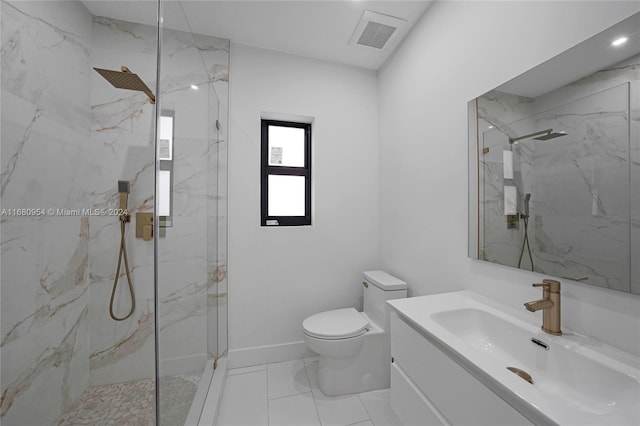 bathroom featuring vanity, toilet, and a tile shower