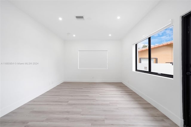 unfurnished room with light wood-type flooring