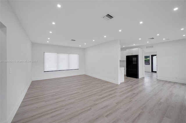 unfurnished living room with light hardwood / wood-style flooring