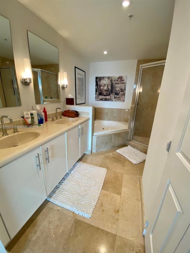 bathroom featuring vanity and shower with separate bathtub