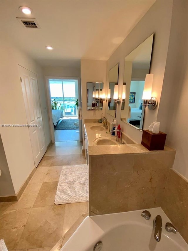 bathroom with vanity and a relaxing tiled tub