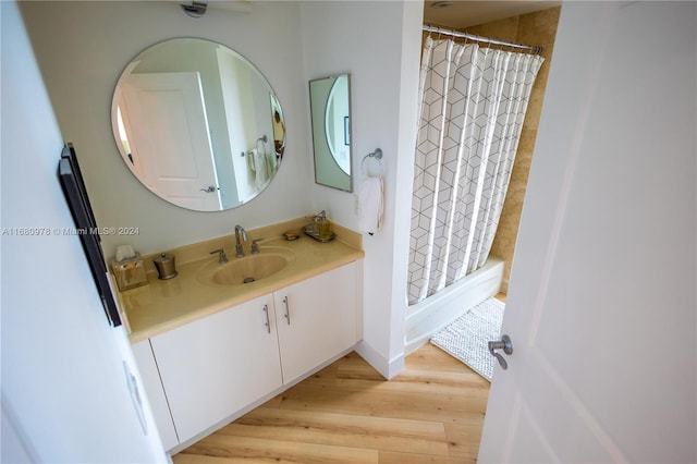 bathroom featuring vanity, hardwood / wood-style floors, and a shower with shower curtain