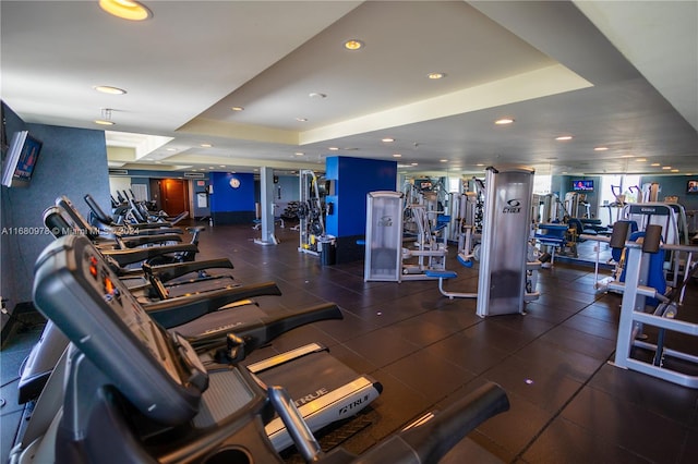 workout area featuring a tray ceiling