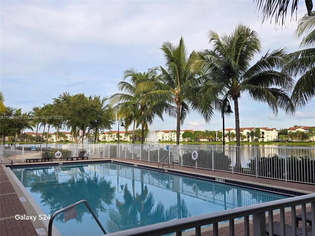 view of swimming pool with a water view