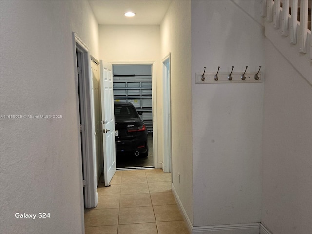 hall featuring light tile patterned floors