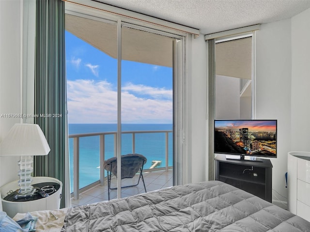 tiled bedroom with multiple windows and a textured ceiling