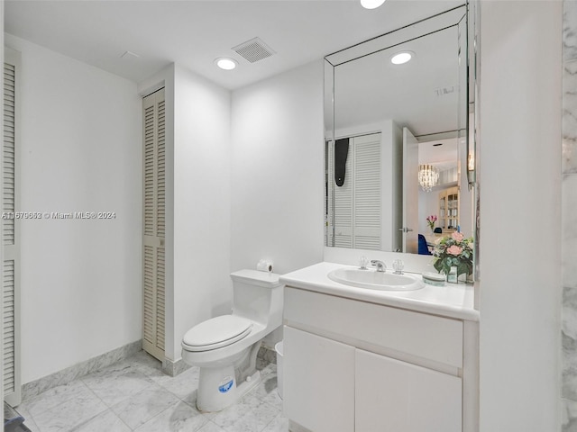 bathroom featuring vanity and toilet