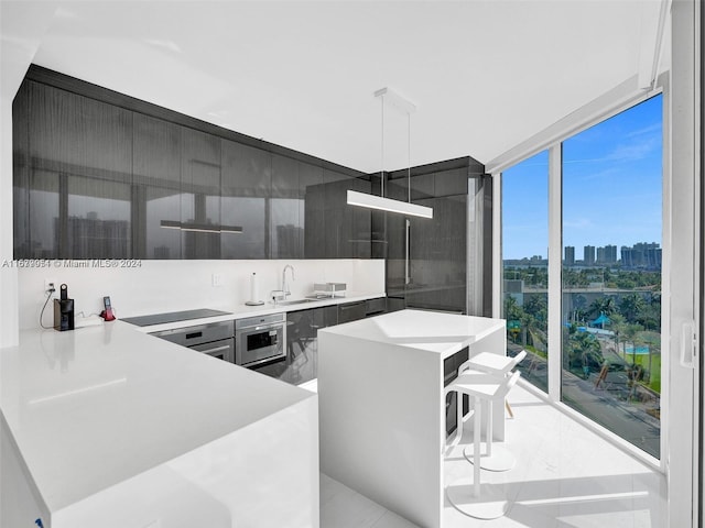 kitchen featuring oven, a center island, a healthy amount of sunlight, and black electric cooktop