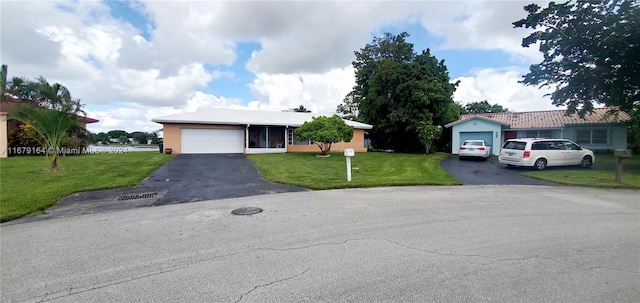 view of front facade featuring a front yard and a garage