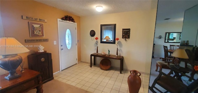 entryway featuring a textured ceiling and light tile patterned floors