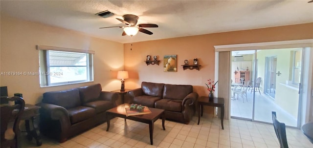 tiled living room with ceiling fan