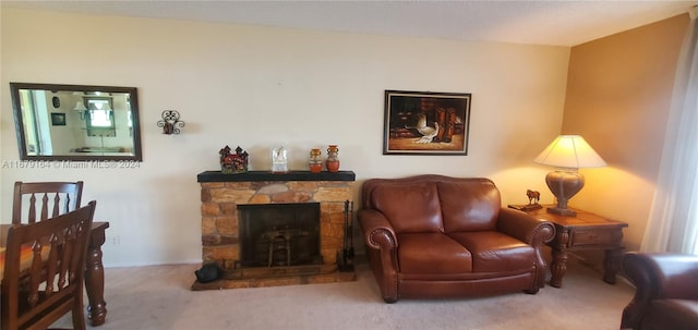 carpeted living room featuring a stone fireplace