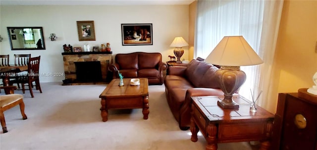 living room featuring a fireplace and light colored carpet