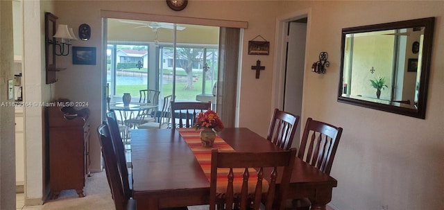 carpeted dining space featuring ceiling fan