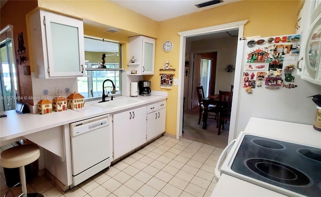 kitchen featuring white cabinetry, sink, and white appliances