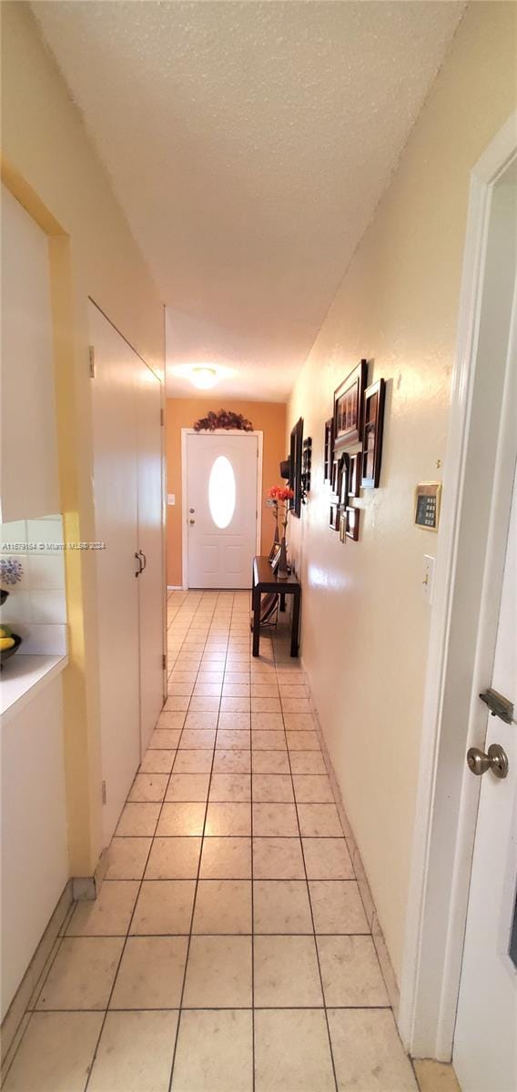 hallway featuring light tile patterned floors