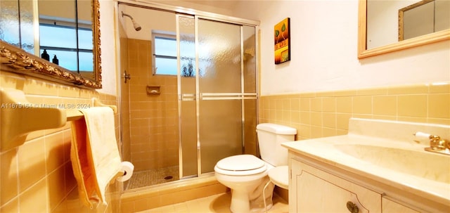 bathroom with walk in shower, tile walls, and vanity