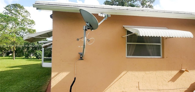 view of side of property with a yard