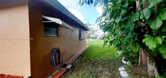 view of side of home featuring a lawn