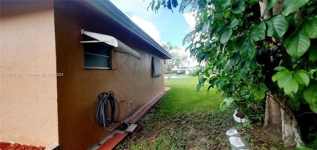 9401 NW 70th Pl, Tamarac, FL 33321 - view of home's exterior featuring stucco siding and a yard
