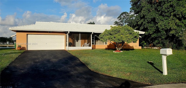 ranch-style house featuring a garage and a front yard