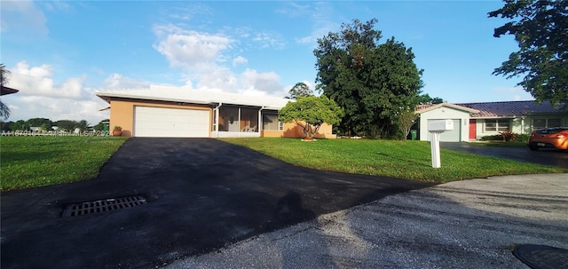 ranch-style home featuring a garage and a front yard