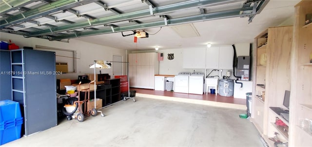 garage featuring washer and clothes dryer, a garage door opener, and electric panel