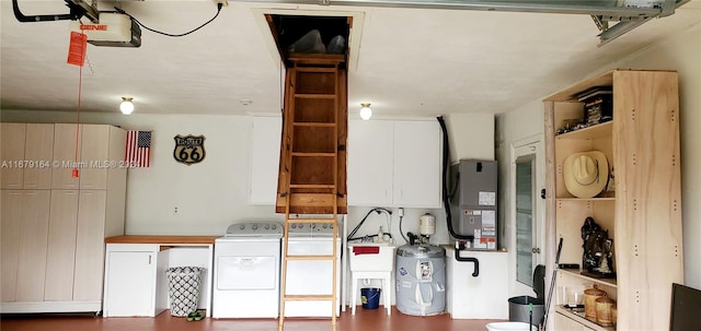 interior space with a garage door opener, sink, and independent washer and dryer