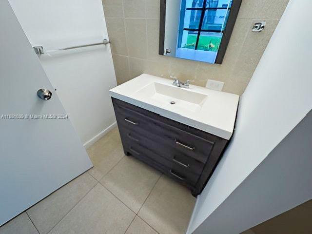 bathroom featuring vanity, tile walls, and tile patterned floors