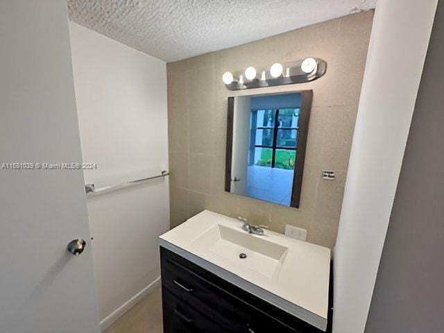 bathroom with vanity and a textured ceiling