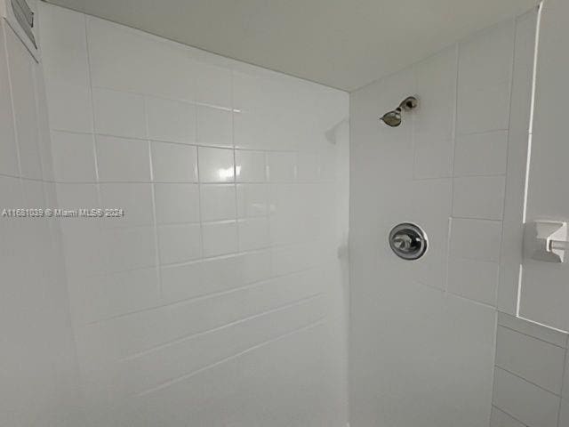 bathroom with tiled shower