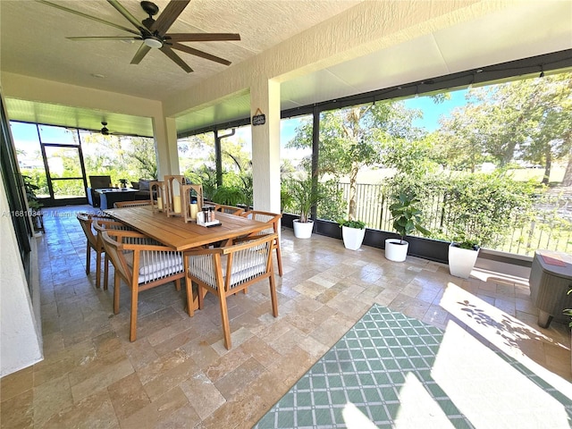 sunroom / solarium featuring ceiling fan