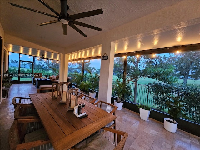 sunroom / solarium featuring ceiling fan