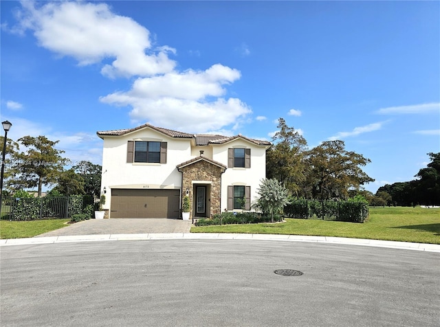 mediterranean / spanish-style home featuring a garage and a front lawn