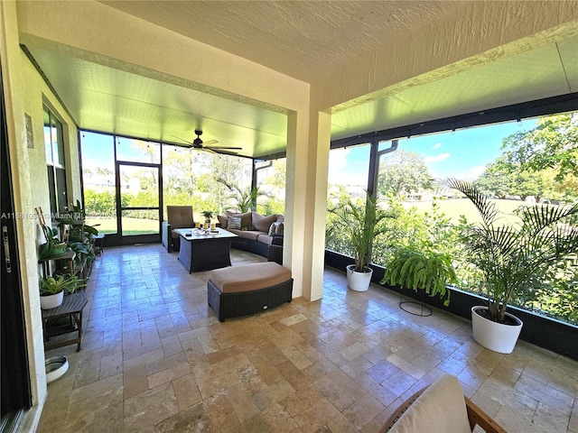 sunroom / solarium featuring ceiling fan and plenty of natural light