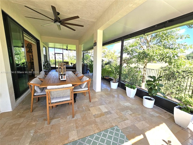 sunroom / solarium featuring ceiling fan