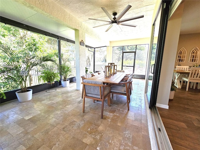 sunroom / solarium featuring ceiling fan