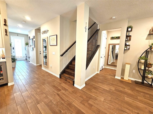 interior space featuring a textured ceiling and wood-type flooring