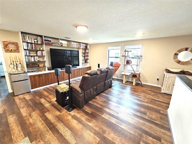 living room featuring a textured ceiling and dark hardwood / wood-style flooring