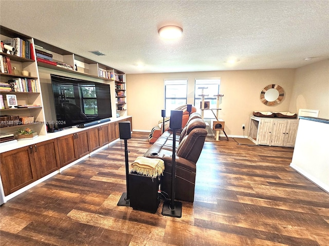 living room featuring a textured ceiling and dark hardwood / wood-style flooring