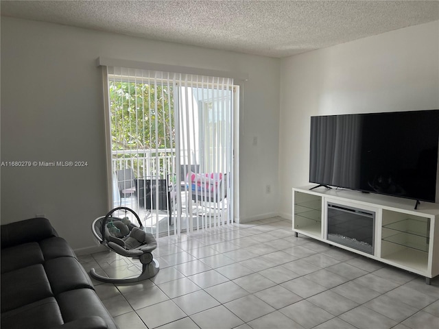 unfurnished living room with a textured ceiling and light tile patterned floors