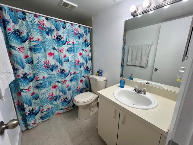 bathroom with vanity, a shower with curtain, toilet, and tile patterned flooring