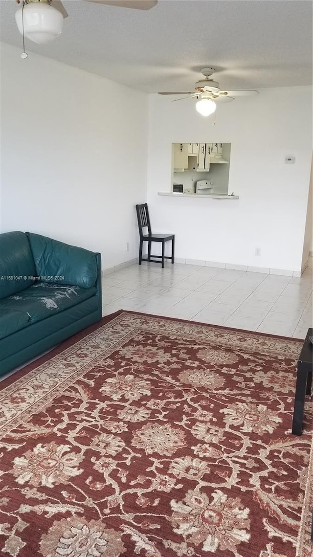 living room featuring tile patterned flooring and ceiling fan