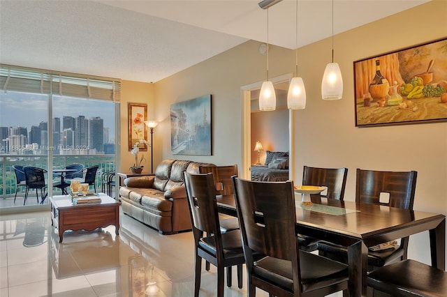 tiled dining room with a textured ceiling