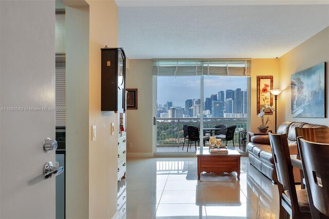 living room with a textured ceiling and light tile patterned flooring