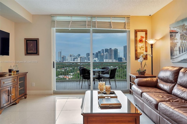 living room featuring a healthy amount of sunlight, light tile patterned floors, and a textured ceiling