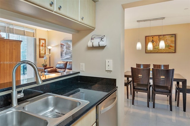 kitchen featuring dishwasher, sink, and hanging light fixtures