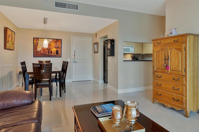 living room with light tile patterned flooring and sink