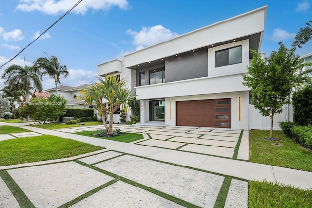 modern home with a front yard and a garage