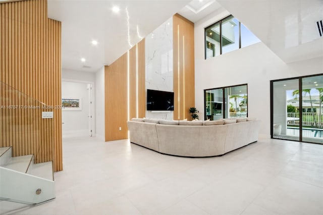 tiled living room featuring a towering ceiling